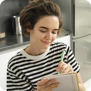 picture of woman writing, smiling
