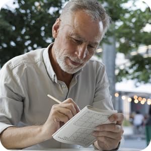 Photo of older man writing, smiling