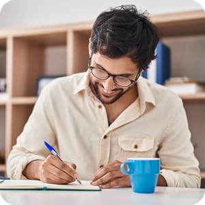 man smiling and writing