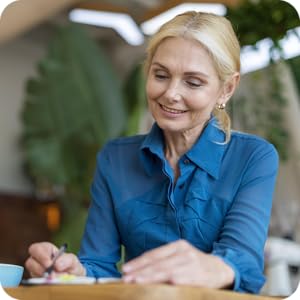 woman smiling and writing